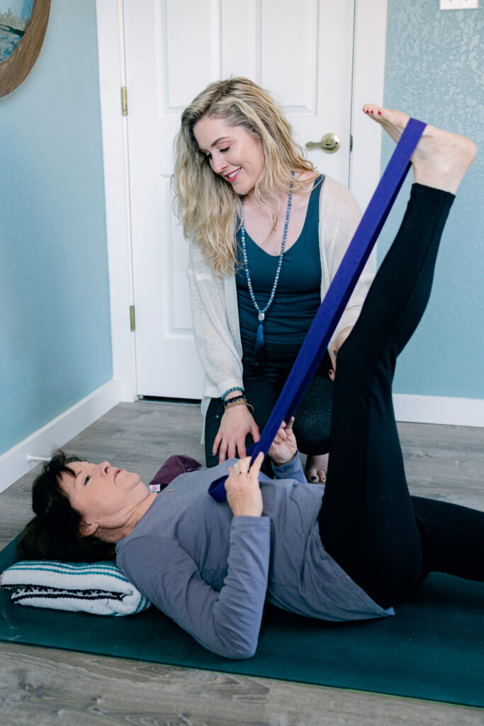 What is yoga therapy and who is a yoga therapist? Mikah works with a 1:1 yoga therapy client using yoga props.