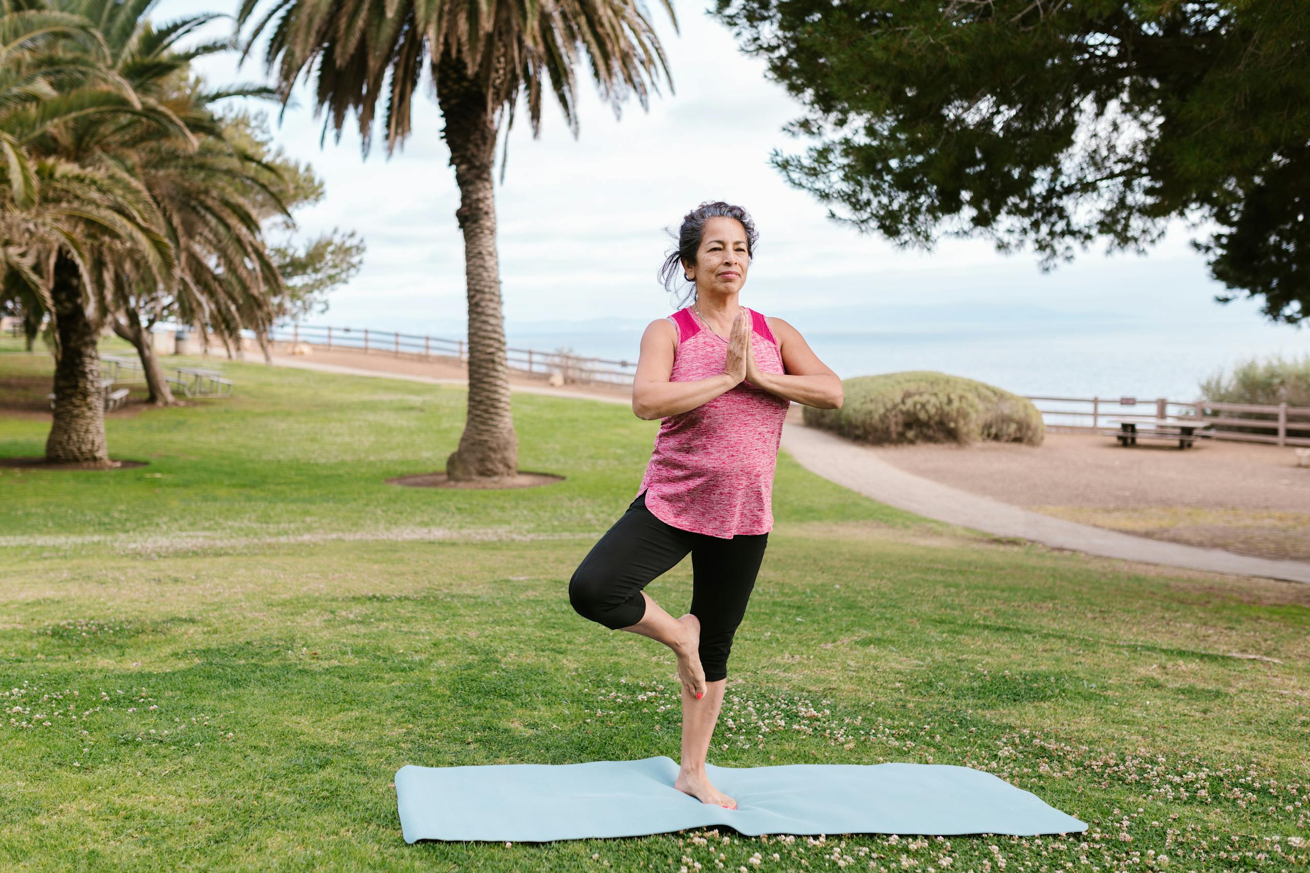 A Woman Doing Yoga and Balancing in Tree Pose