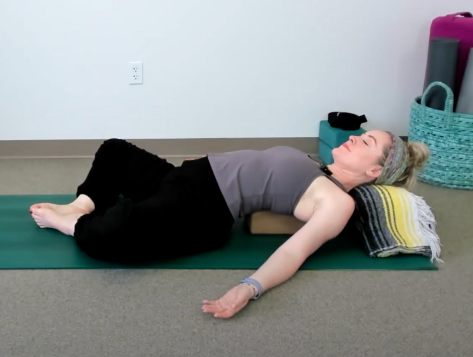 Supported Fish Pose with yoga props to reverse rounded shoulders