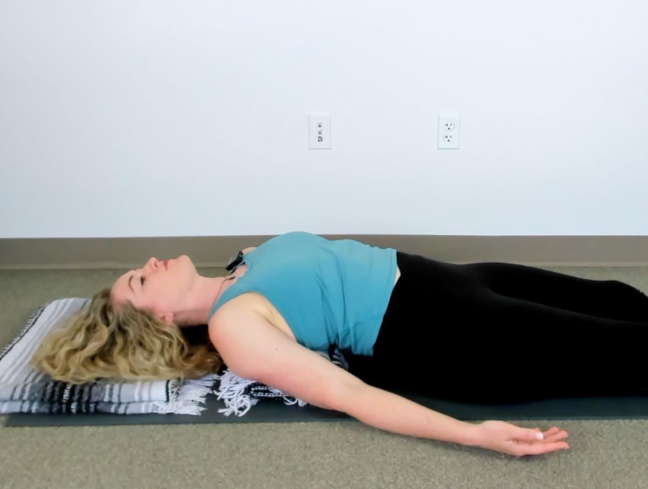 Mikah Horn demonstrating Supported FIsh Pose for spinal mobility, posture, and thoracic extension.