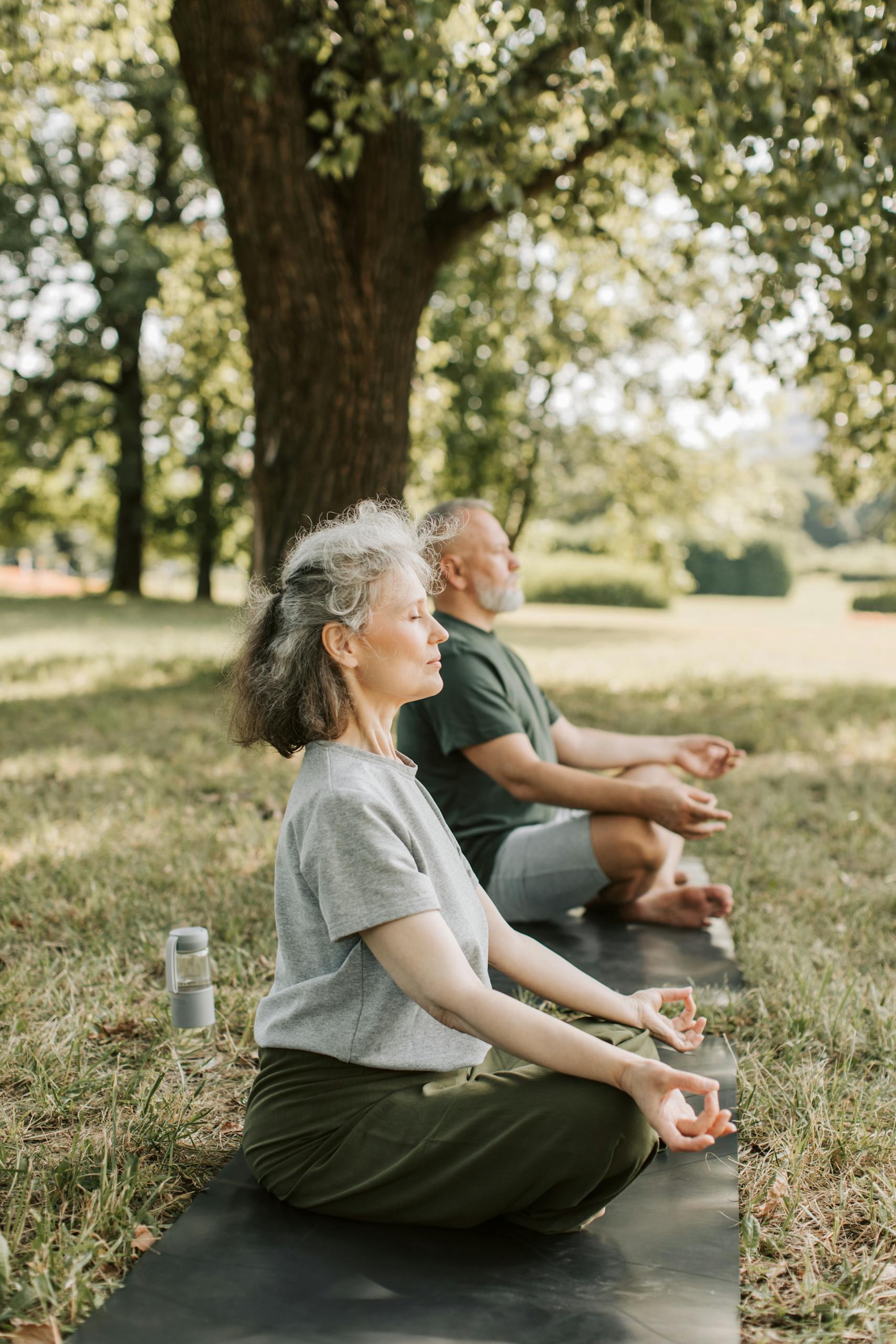 Two Seniors Meditating in the Park