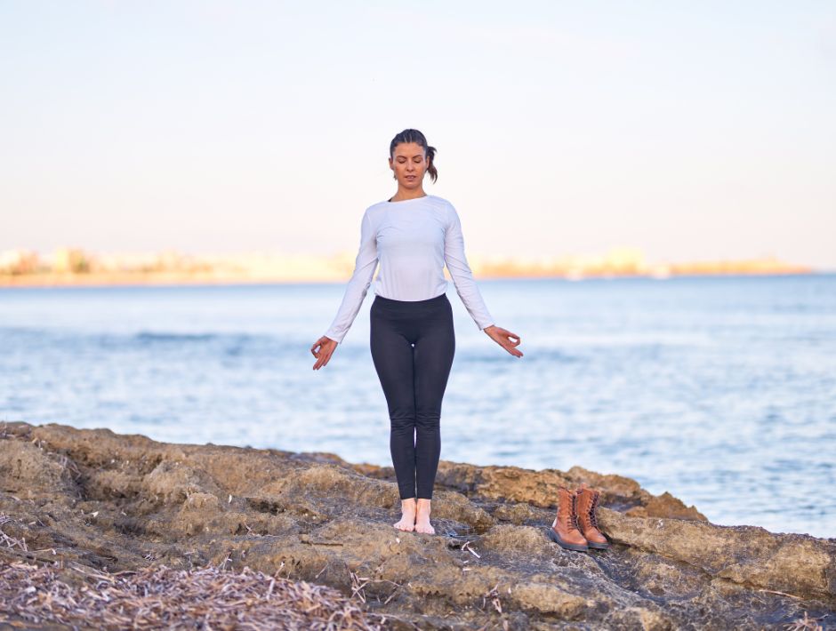 Woman standing in mountain pose by the water. Balance and Fall Prevention