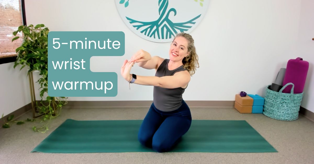 yoga teacher demonstrating wrist warmup to prevent pain and build strength