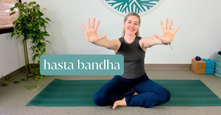 Yoga teacher demonstrating Hasta Bandha, a hand placement technique for protecting your wrists.